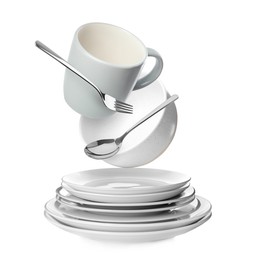 Image of Clean dishware and silverware flying over stacked plates on white background