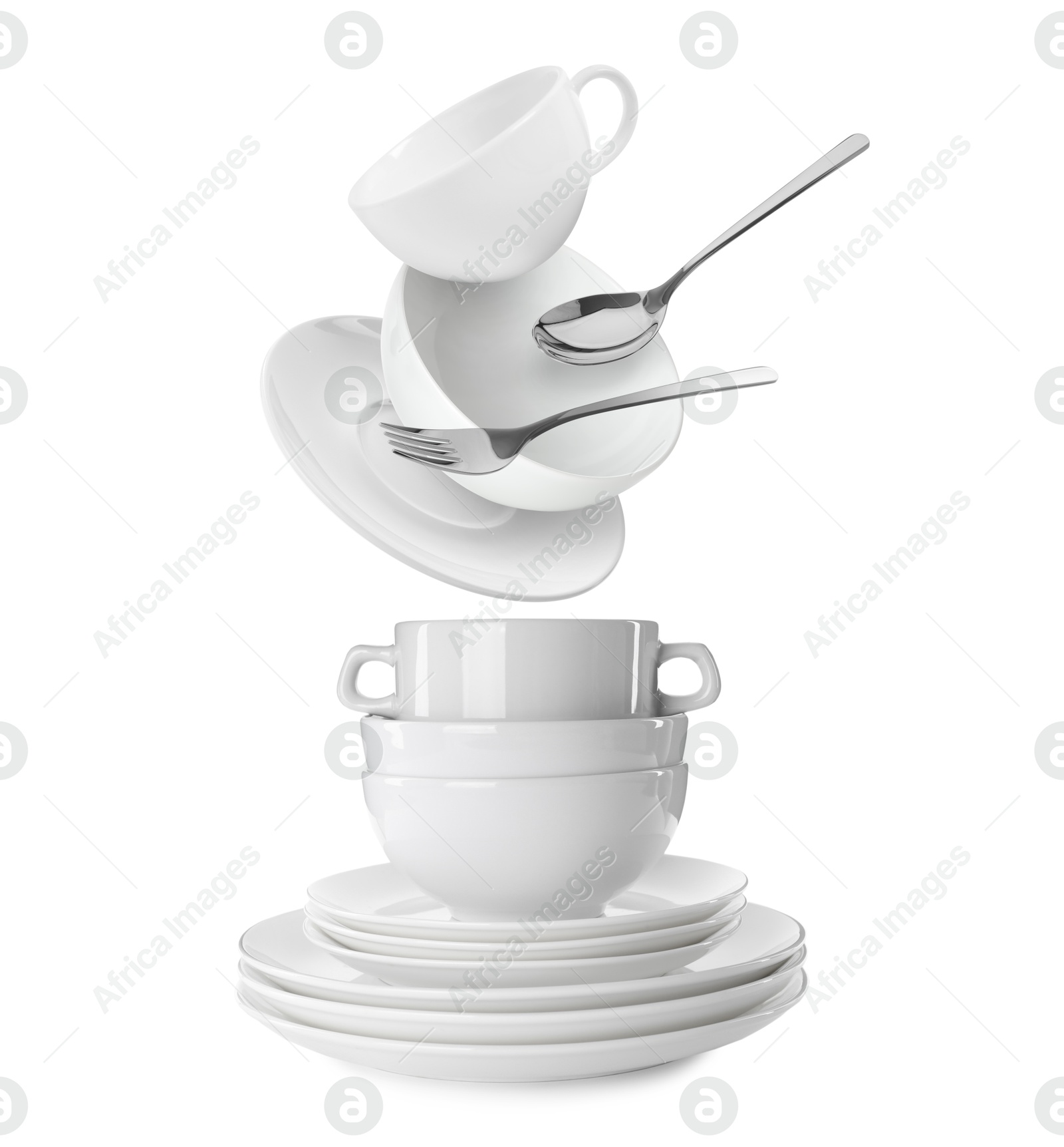 Image of Clean dishware and silverware flying over tableware on white background