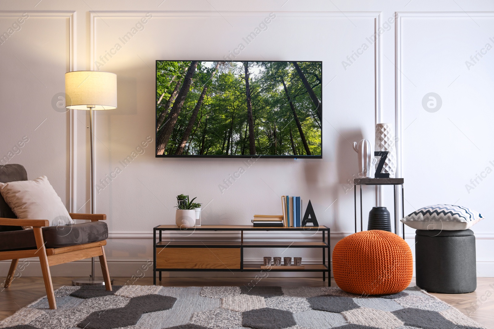 Image of TV set with nature landscape on screen in room