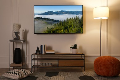 Image of TV set with mountain landscape on screen in room