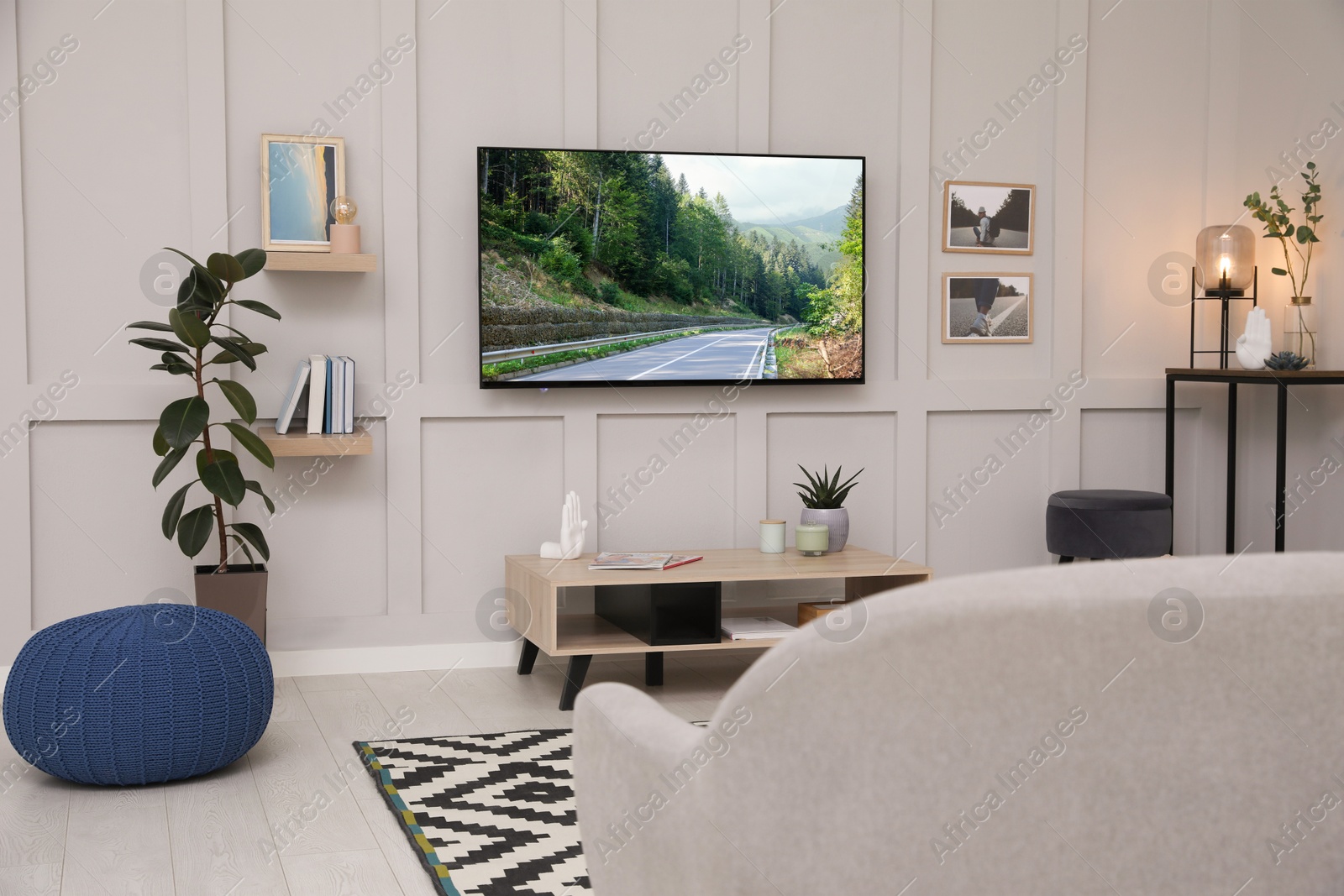 Image of TV set with mountain landscape on screen in room