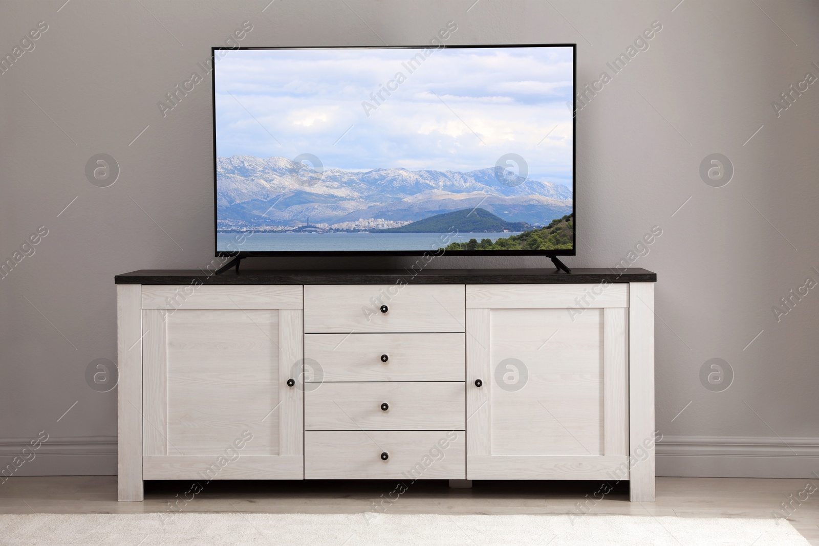 Image of TV set with mountain landscape on screen in room