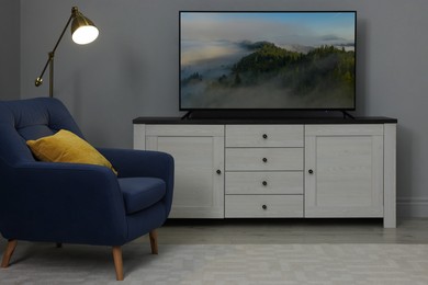 Image of TV set with mountain landscape on screen in room