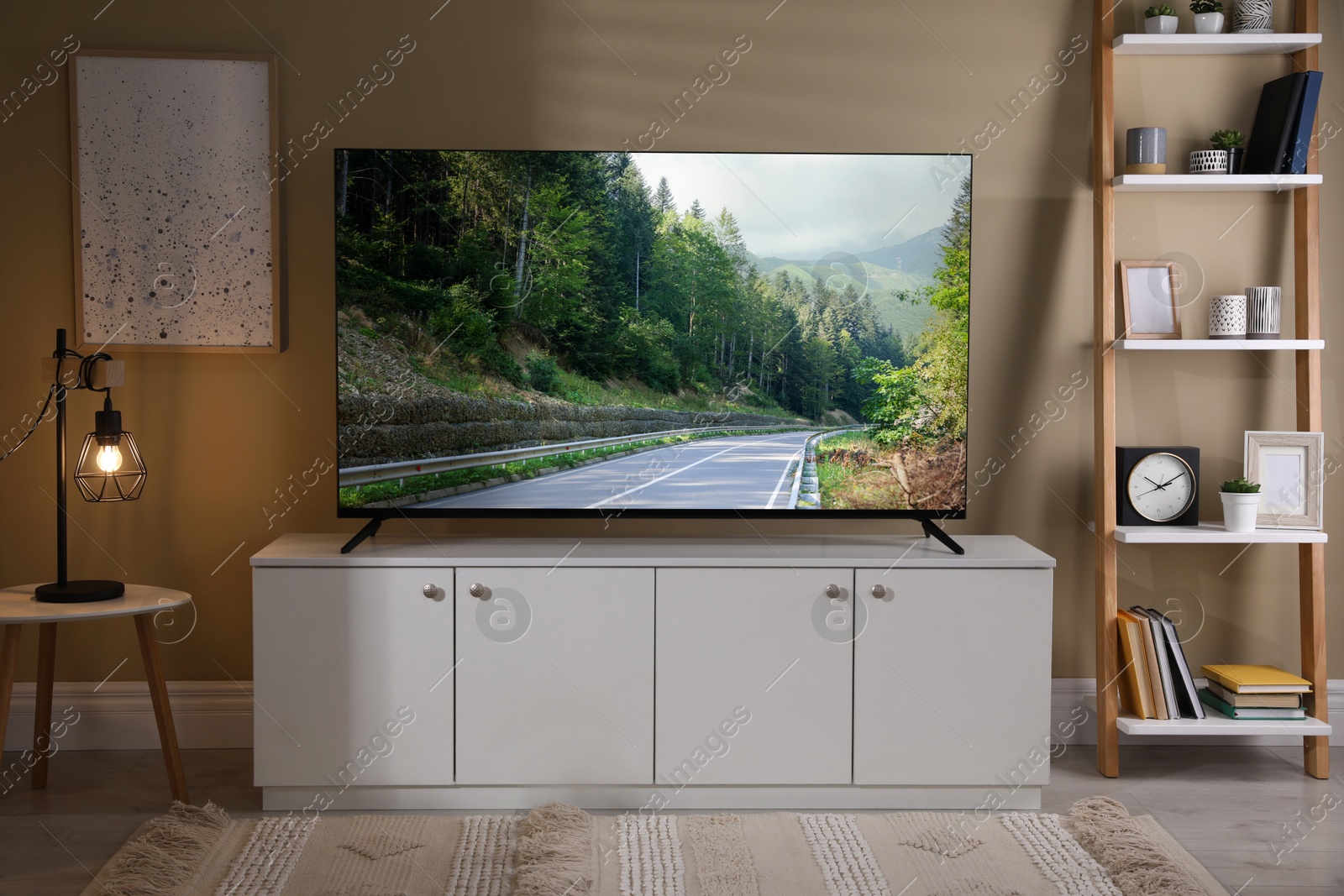 Image of TV set with mountain landscape on screen in room