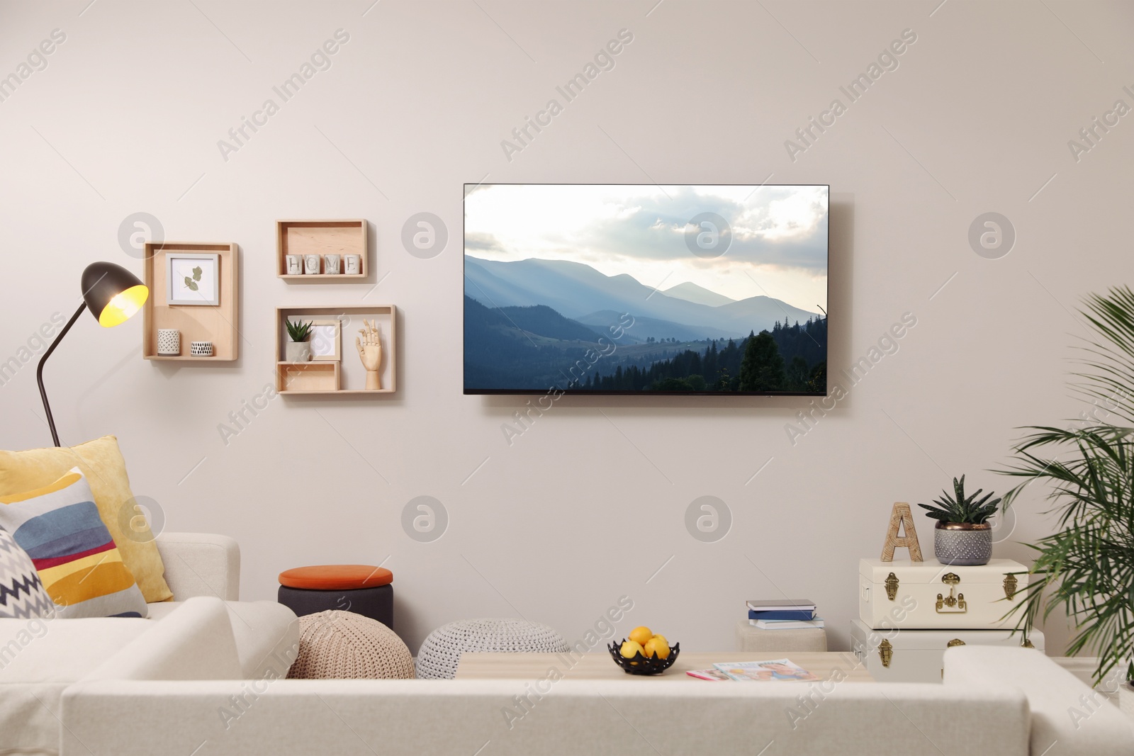 Image of TV set with mountain landscape on screen in room