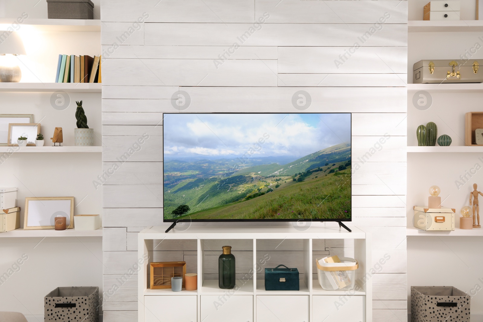 Image of TV set with mountain landscape on screen in room