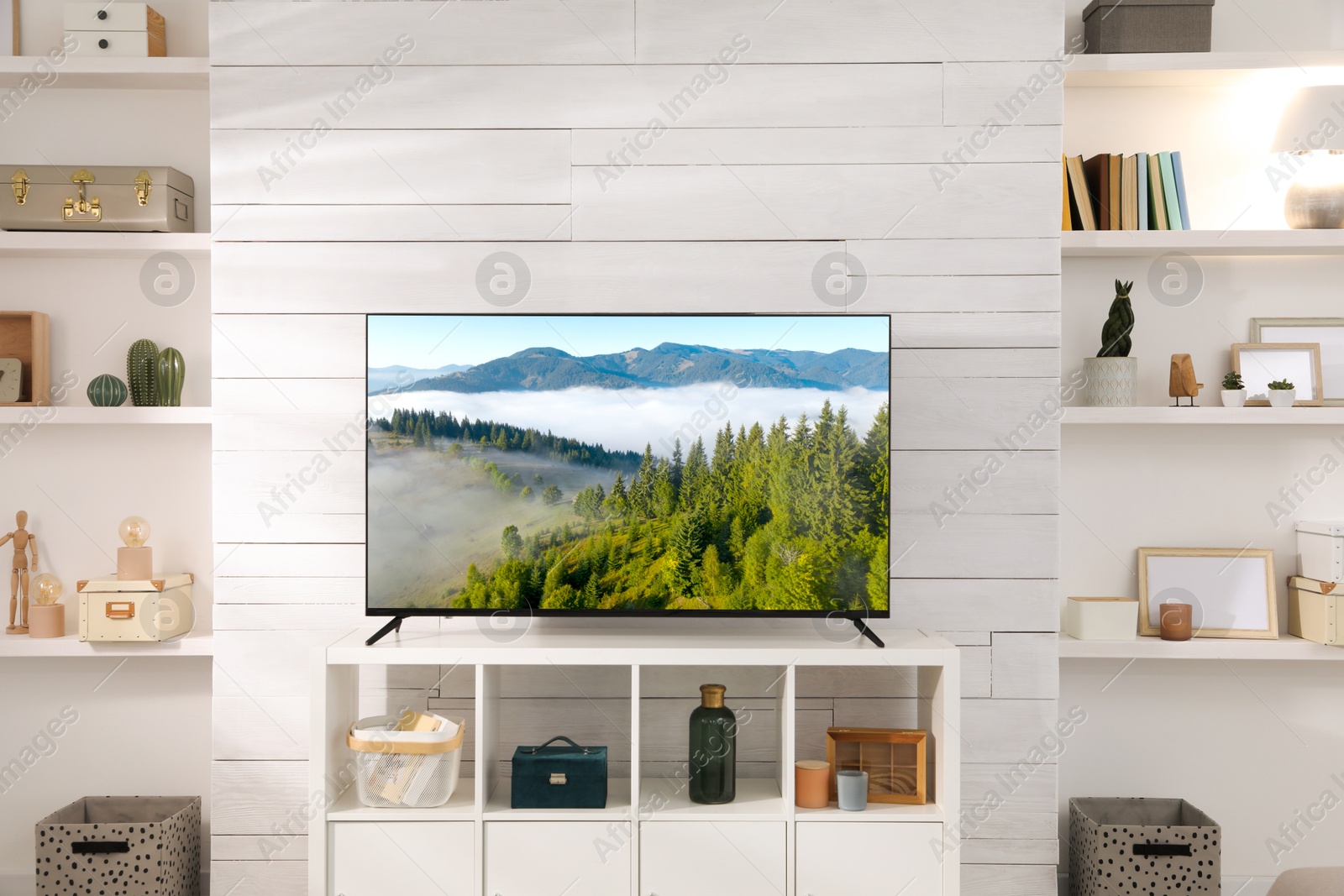 Image of TV set with mountain landscape on screen in room