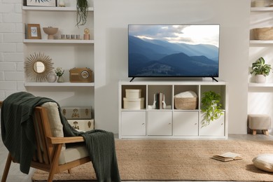 Image of TV set with mountain landscape on screen in room