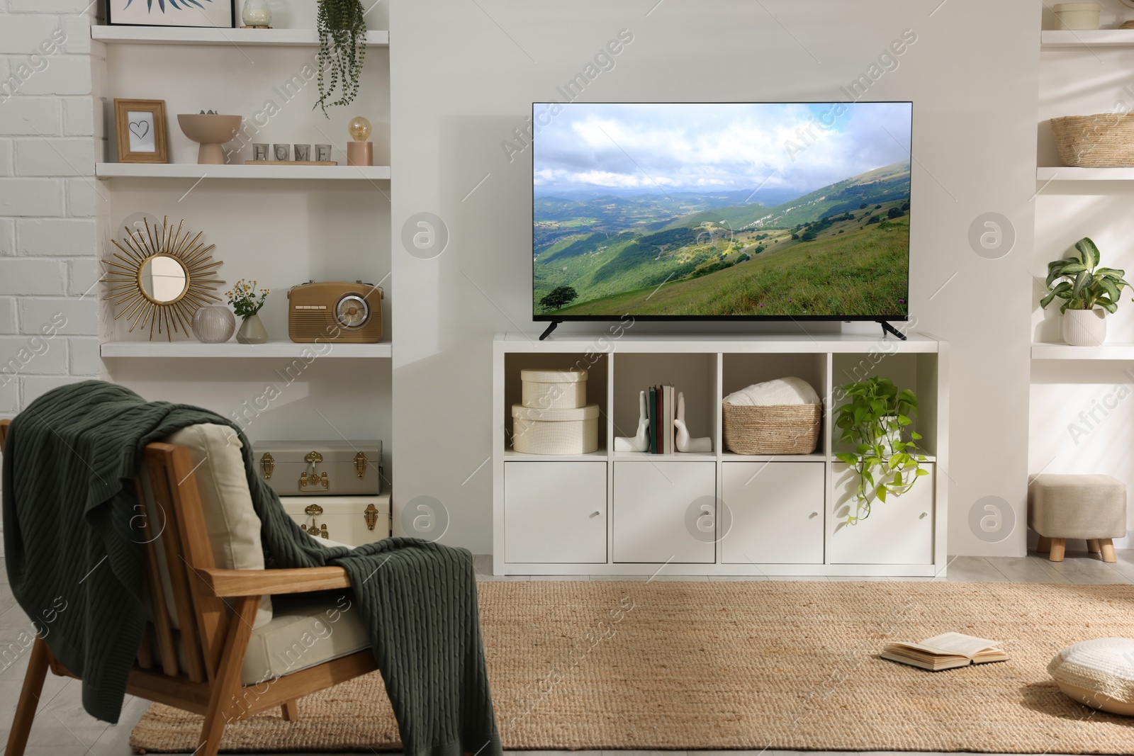 Image of TV set with mountain landscape on screen in room