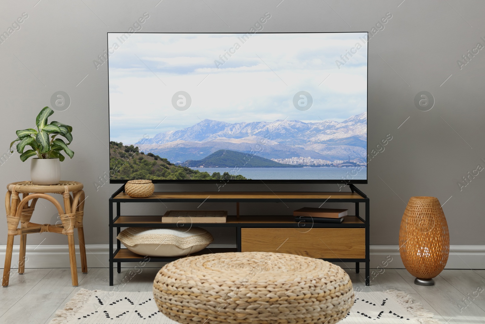 Image of TV set with nature landscape on screen in room