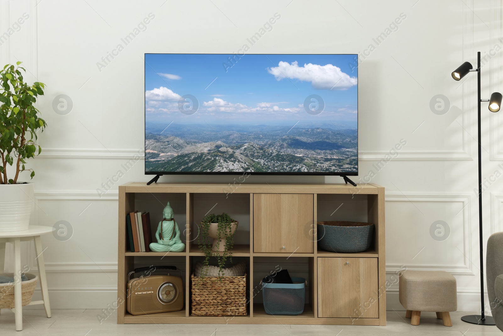 Image of TV set with mountain landscape on screen in room