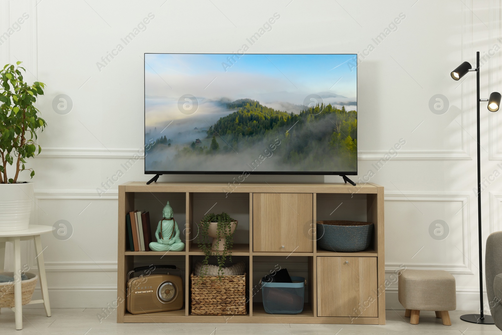 Image of TV set with mountain landscape on screen in room