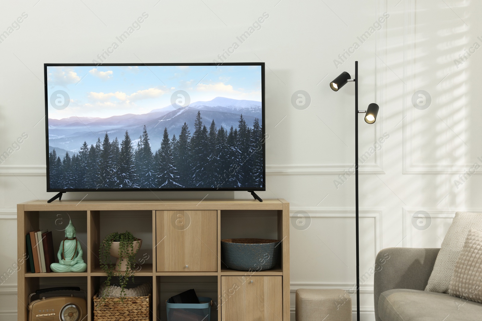 Image of TV set with mountain landscape on screen in room