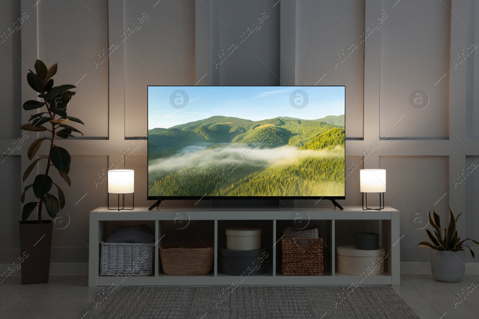 Image of TV set with mountain landscape on screen in room