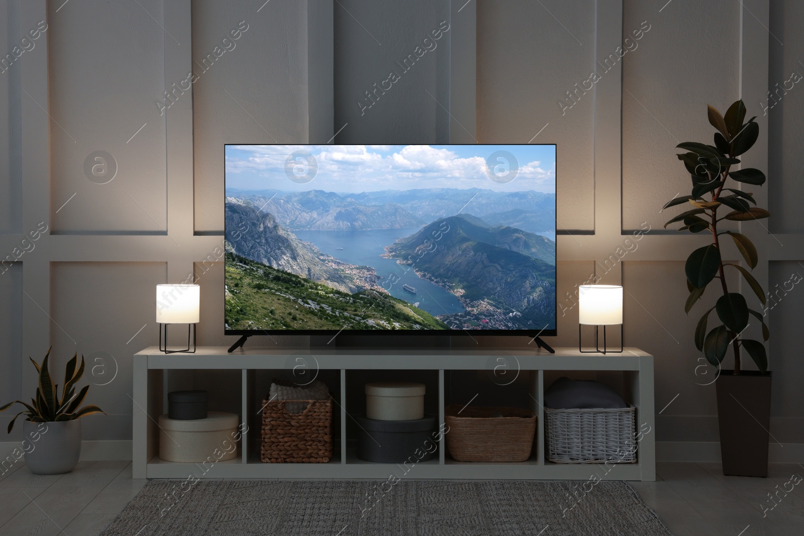 Image of TV set with mountain landscape on screen in room