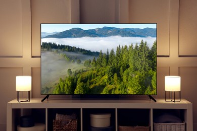 Image of TV set with mountain landscape on screen in room