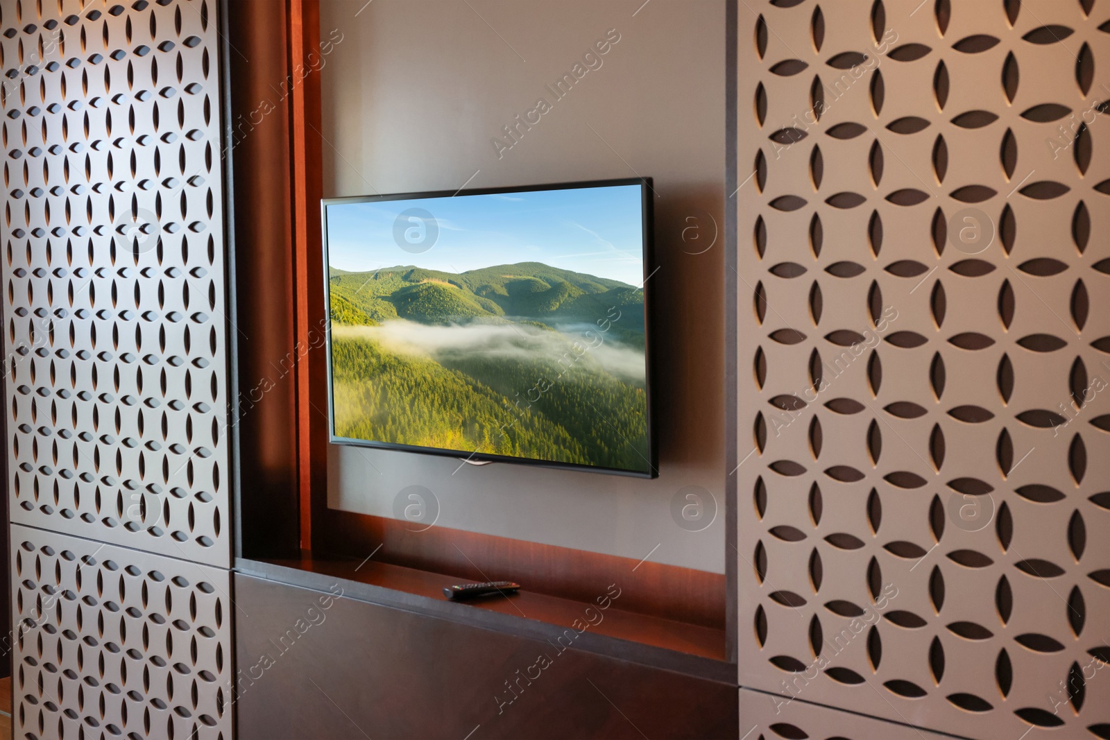 Image of TV set with mountain landscape on screen in room