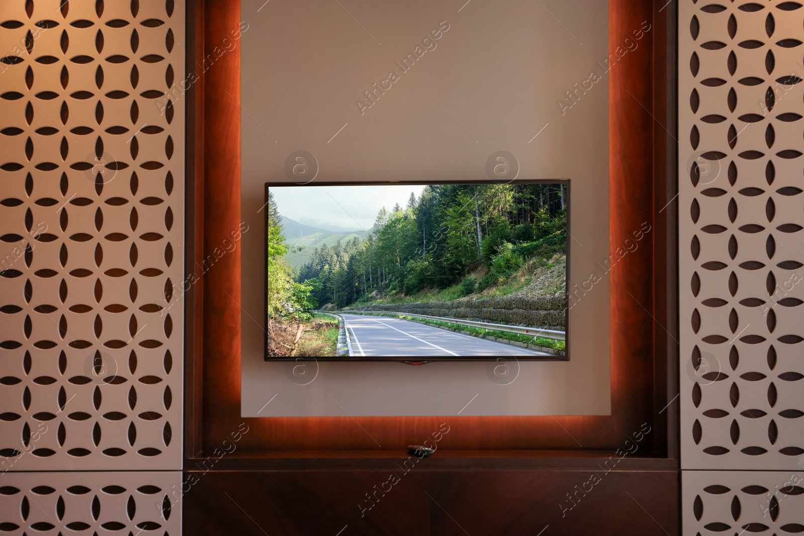 Image of TV set with mountain landscape on screen in room