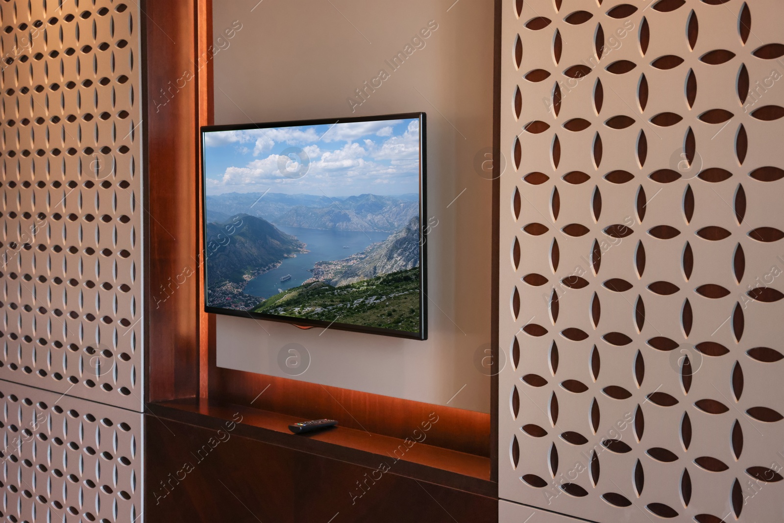 Image of TV set with mountain landscape on screen in room