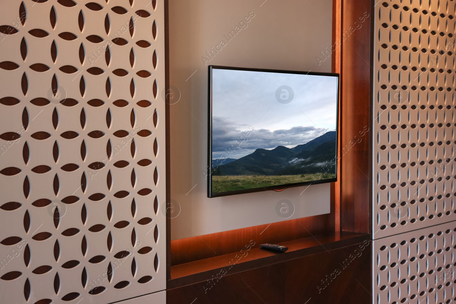 Image of TV set with mountain landscape on screen in room