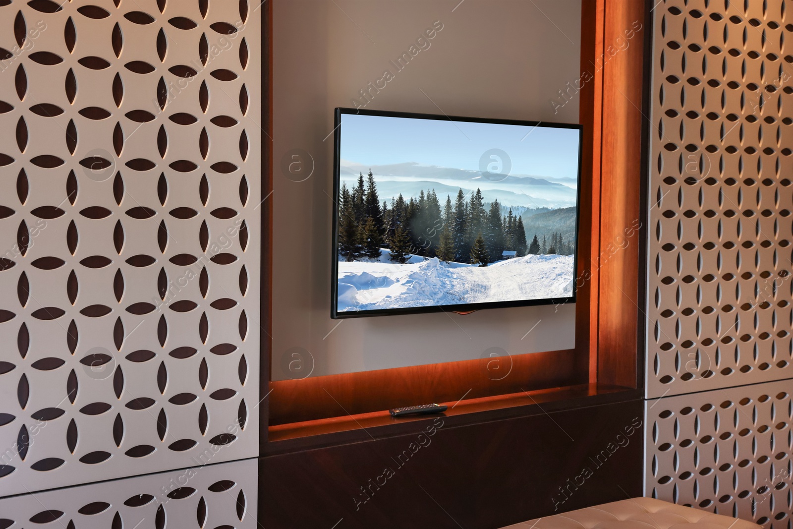 Image of TV set with mountain landscape on screen in room