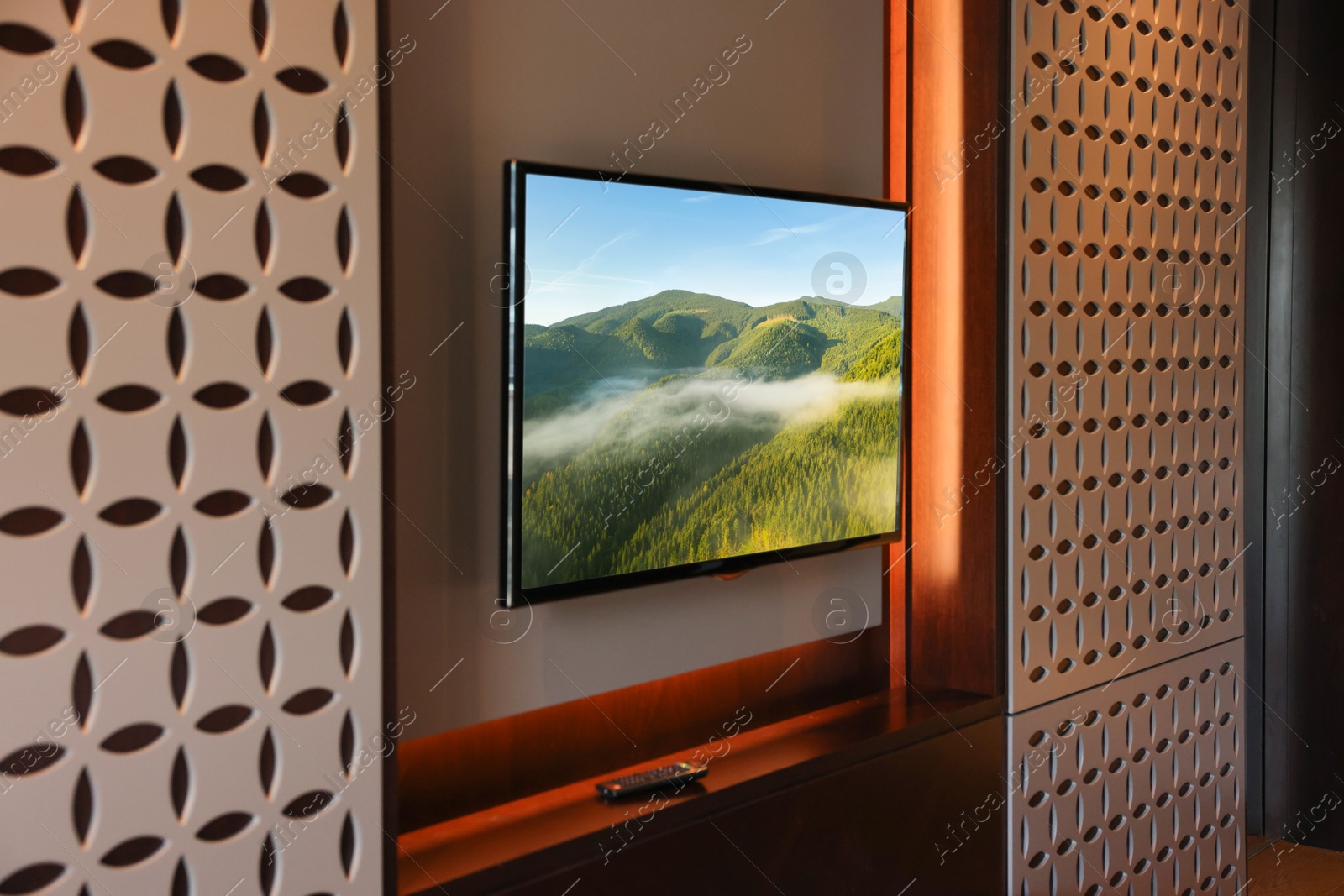 Image of TV set with mountain landscape on screen in room