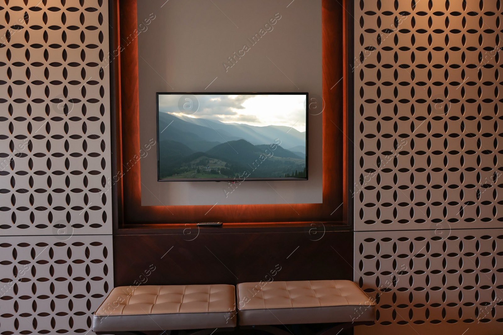 Image of TV set with mountain landscape on screen in room