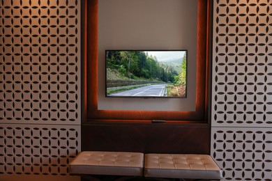 Image of TV set with mountain landscape on screen in room