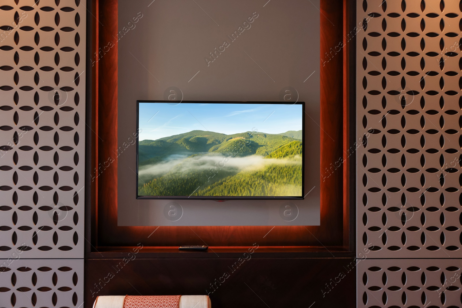 Image of TV set with mountain landscape on screen in room