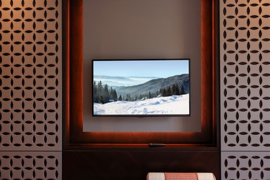 Image of TV set with mountain landscape on screen in room