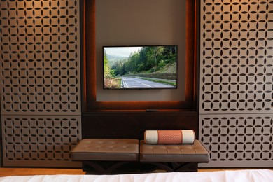 Image of TV set with mountain landscape on screen in room