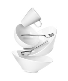 Image of Clean dishware and silverware flying on white background