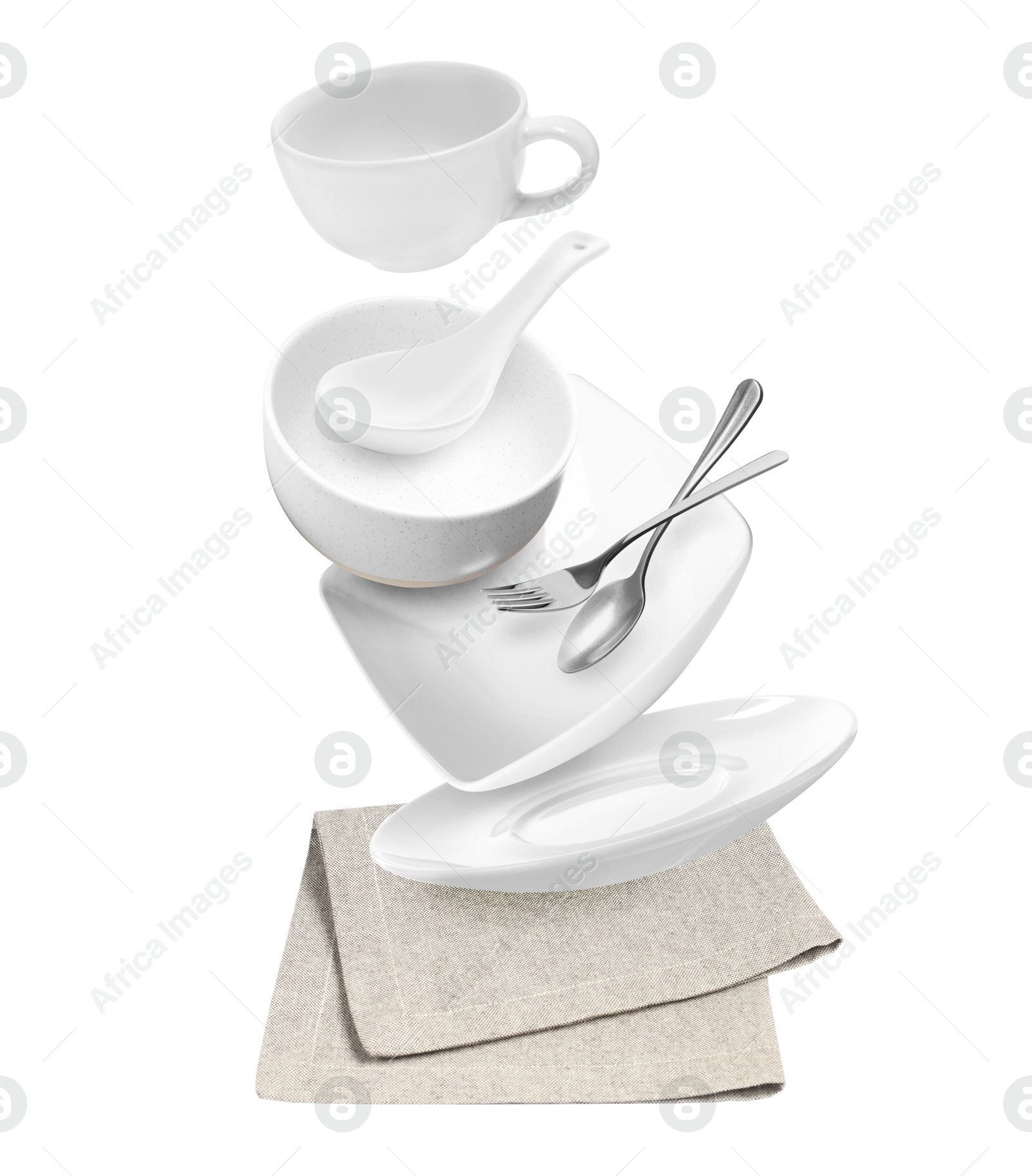 Image of Clean dishware and silverware flying over napkin on white background