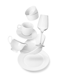 Image of Clean dishware and glass flying on white background