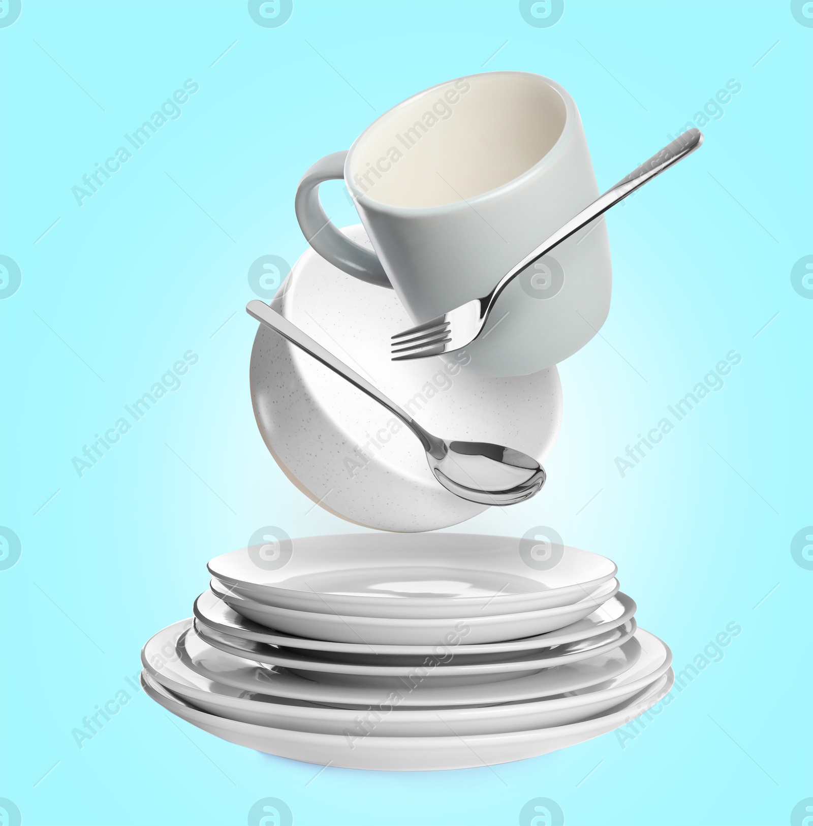 Image of Clean dishware and silverware flying over stacked plates on light blue background