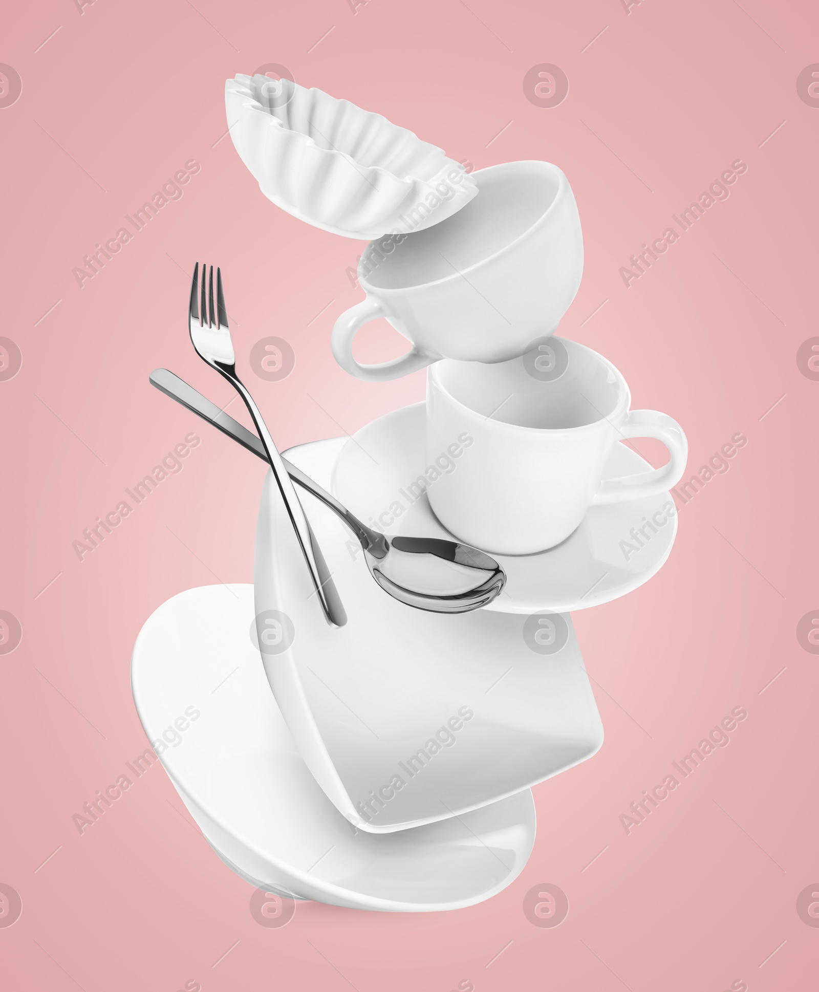 Image of Clean dishware and silverware flying on pink background