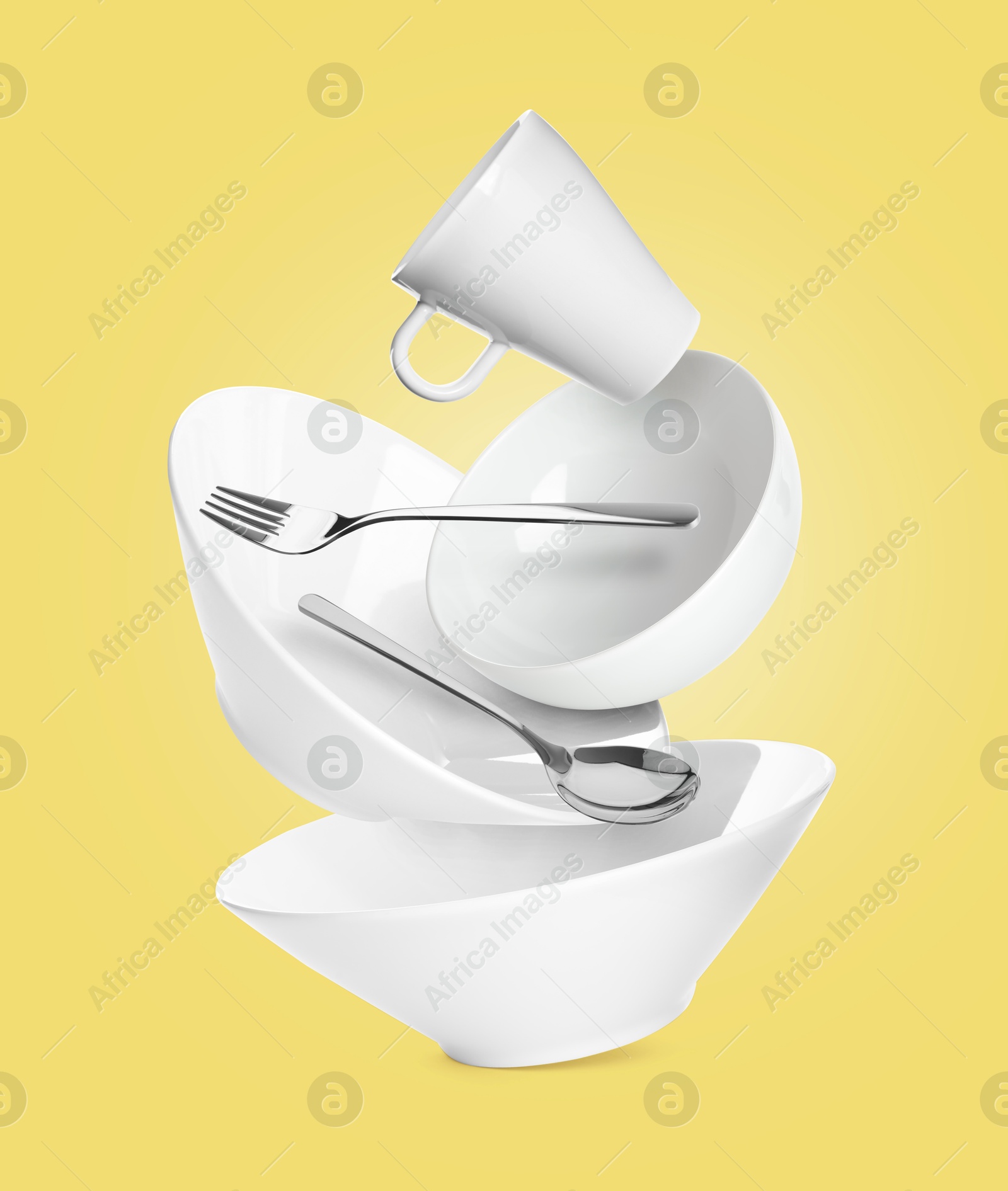 Image of Clean dishware and silverware flying on pastel yellow background