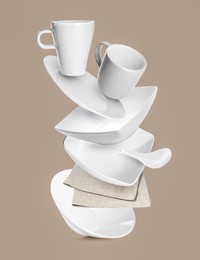 Image of Clean dishware and napkin flying on grey beige background