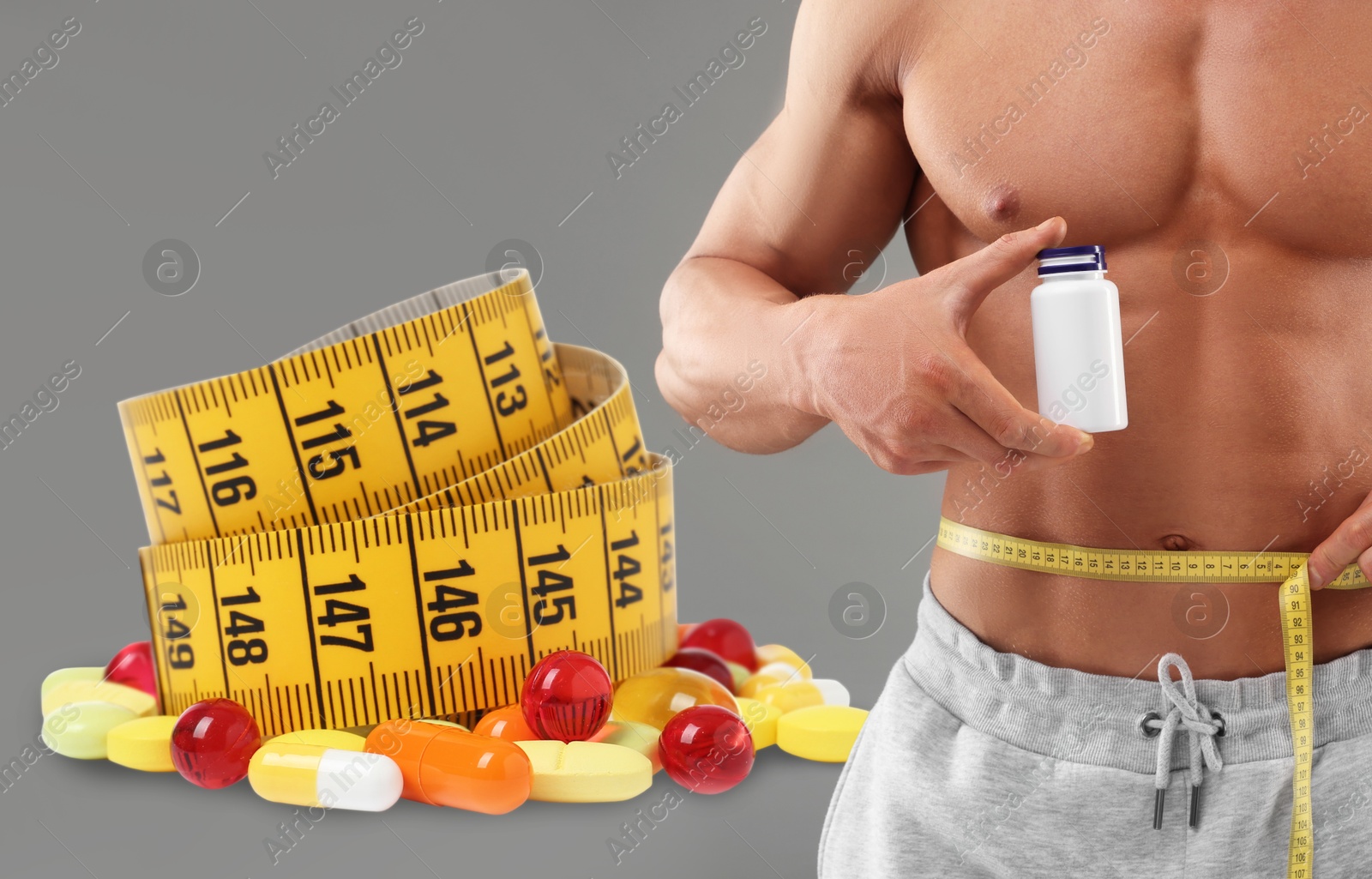 Image of Weight loss. Athletic man holding bottle of supplements and measuring his waist with tape on grey background, closeup