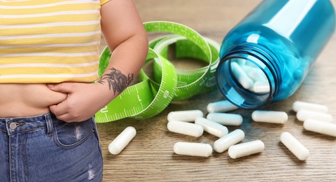 Image of Weight loss. Overweight woman and pills with measuring tape, closeup. Banner design