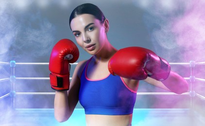 Image of Boxer training on boxing ring in color smoke