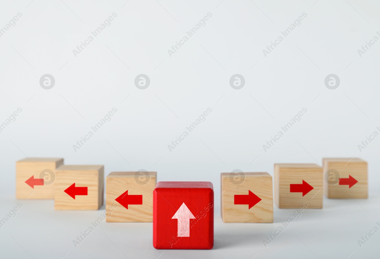 Image of Wooden cubes with arrows pointing in different directions on white background