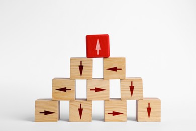 Image of Wooden cubes with arrows pointing in different directions on white background