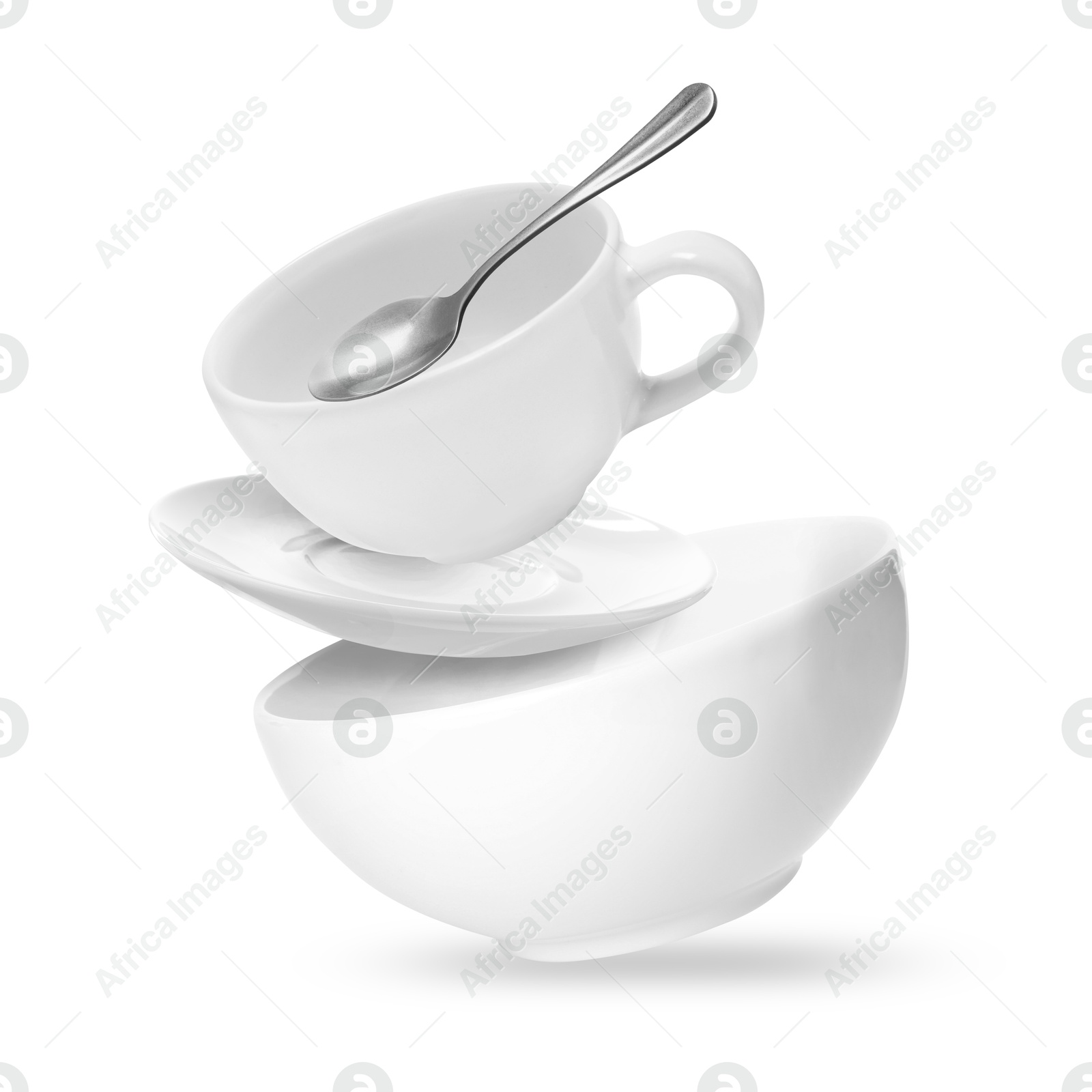 Image of Clean dishware and teaspoon flying on white background