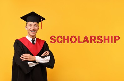 Image of Scholarship. Happy student in academic dress on orange background