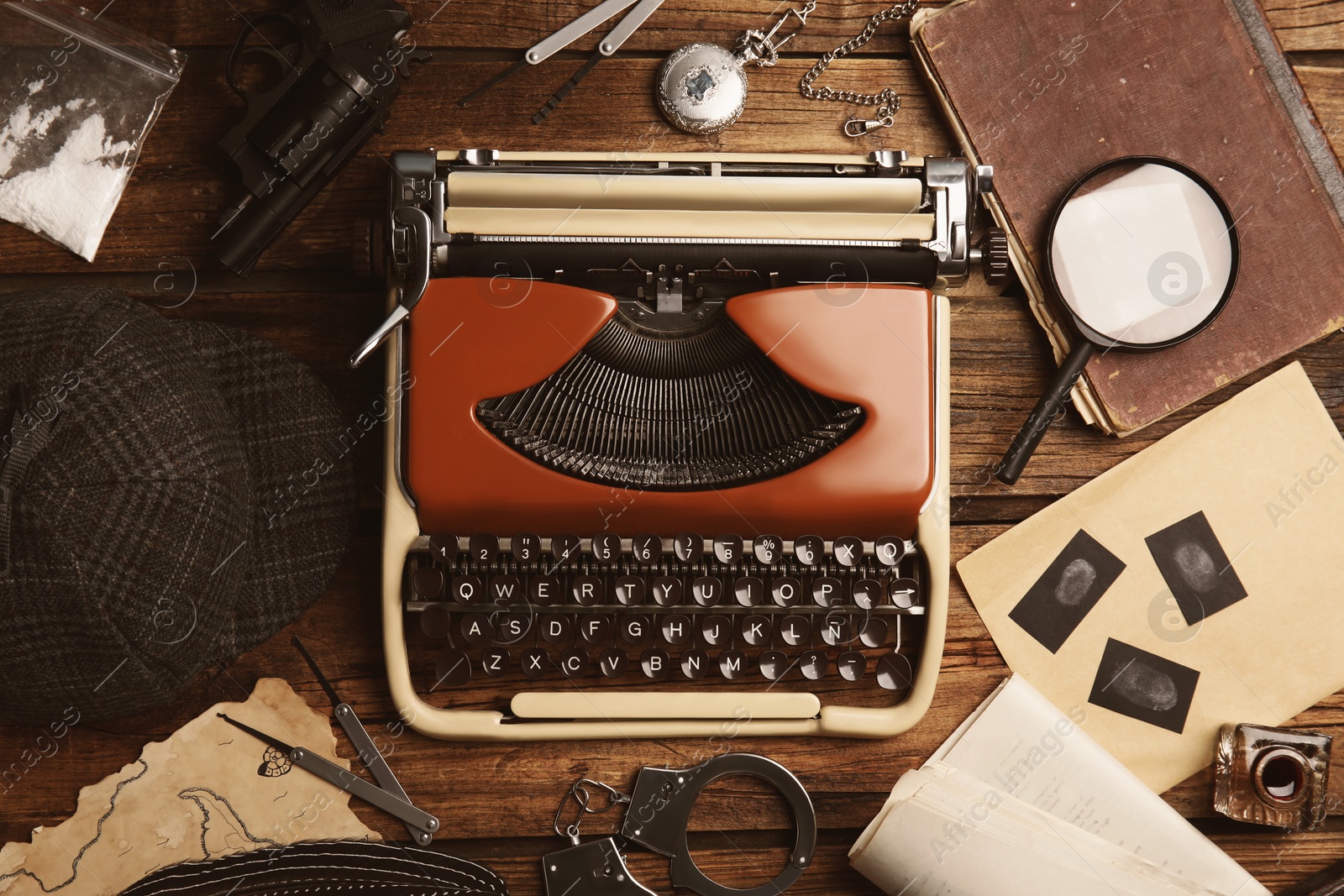 Image of Typewriter, fingerprints, magnifying glass and papers on detective's desk, flat lay