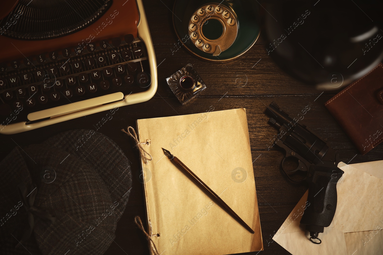 Image of Typewriter, hat, paper, fountain pen and gun on detective's desk, flat lay