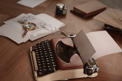 Image of Typewriter, fingerprints, magnifying glass and papers on detective's desk