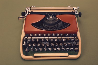 Image of Old typewriter on color background, vintage style toning