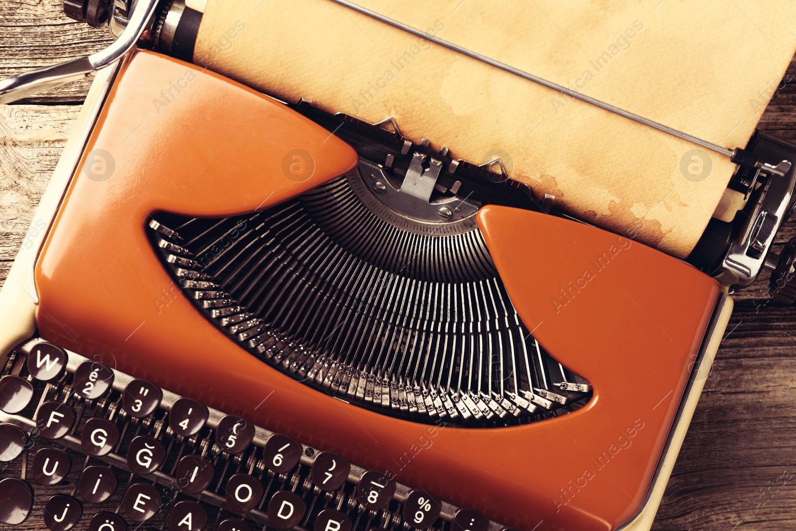 Old vintage typewriter with paper on wooden table, top view Image of Old vintage typewriter with paper on wooden table, top view